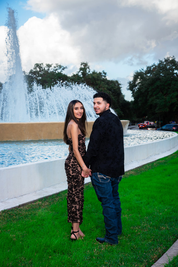 Couple standing together by fountain