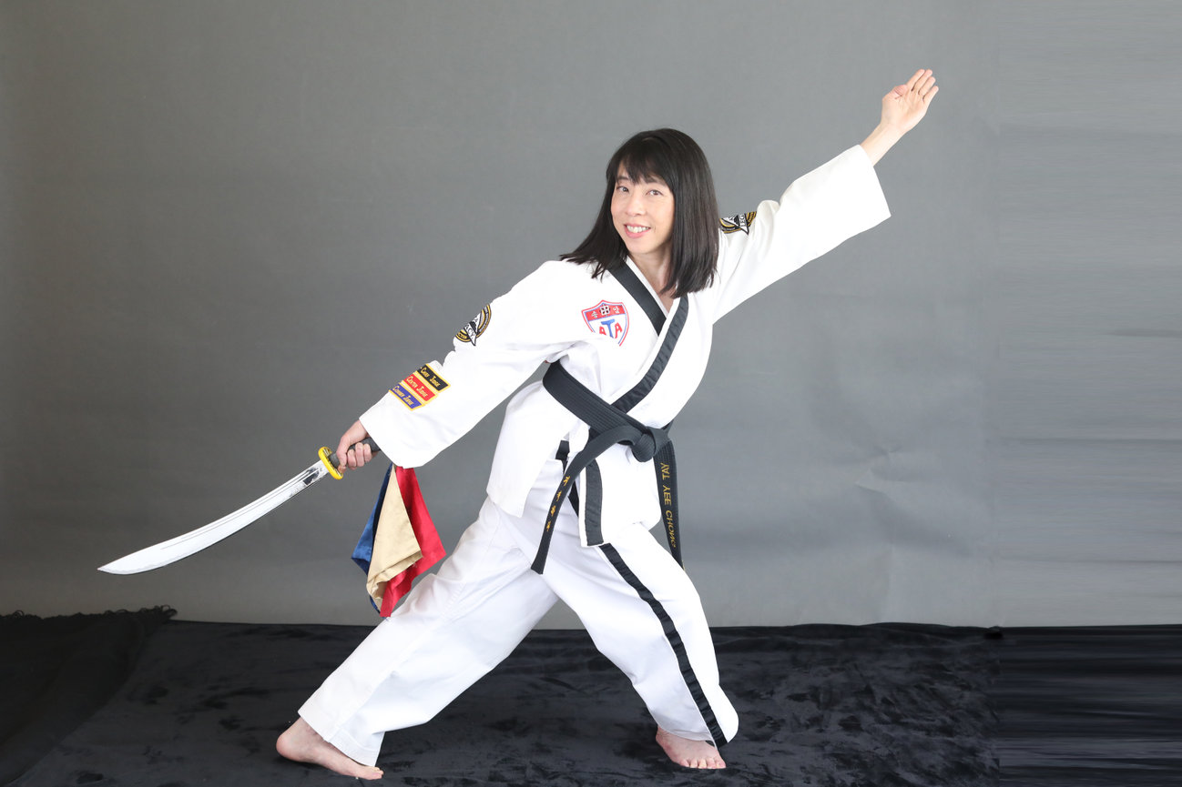 Signature personal brand portrait of female black belt martial artist and business owner. Captured to reflect strength, mastery, and refined leadership. Curated branding photography by Julie Ulstrup, trusted by discerning entrepreneurs professionals