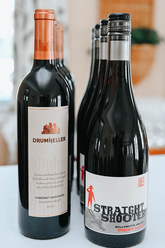 Two bottles of red wine, one from Drumheller (Cabernet Sauvignon) and the other from Straight Shooter (Pinot Noir).