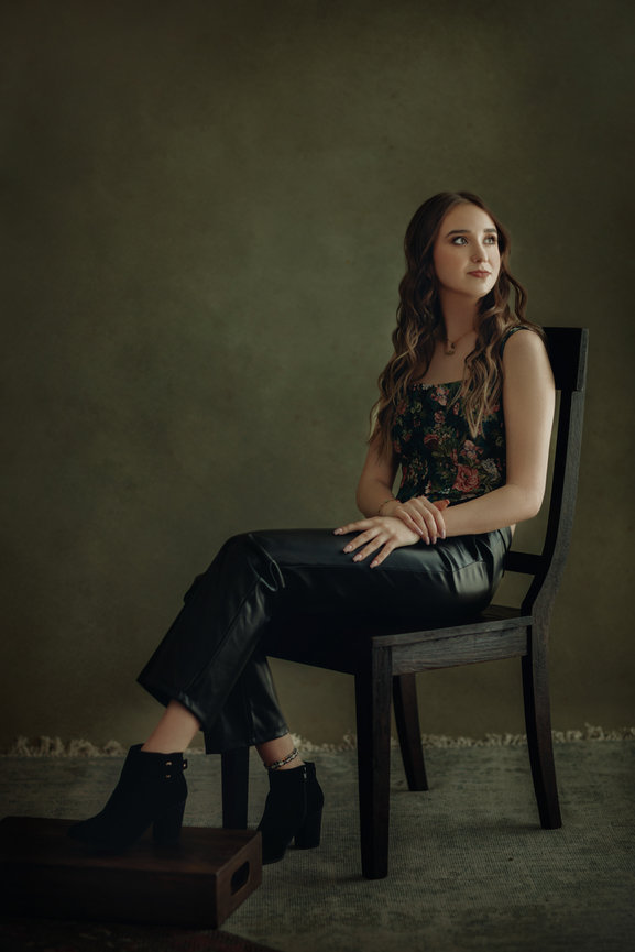 Hip youthful portrait with flower top and greenish backdrop in studio, taken in a photo studio with Adam Trujillo, a Las Vegas portrait photographer.