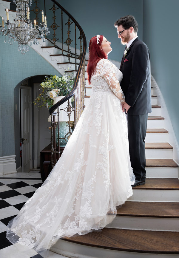 Bride and groom standing together on a spiral staircase after their traditional indoor wedding, captured by Fairhope wedding photographer Dixon Creative Images