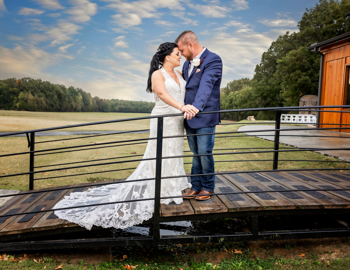 Bride and groom sharing a quiet moment on a bridge at sunset during their outdoor wedding captured by gulf coast photographer Dixon Creative Images