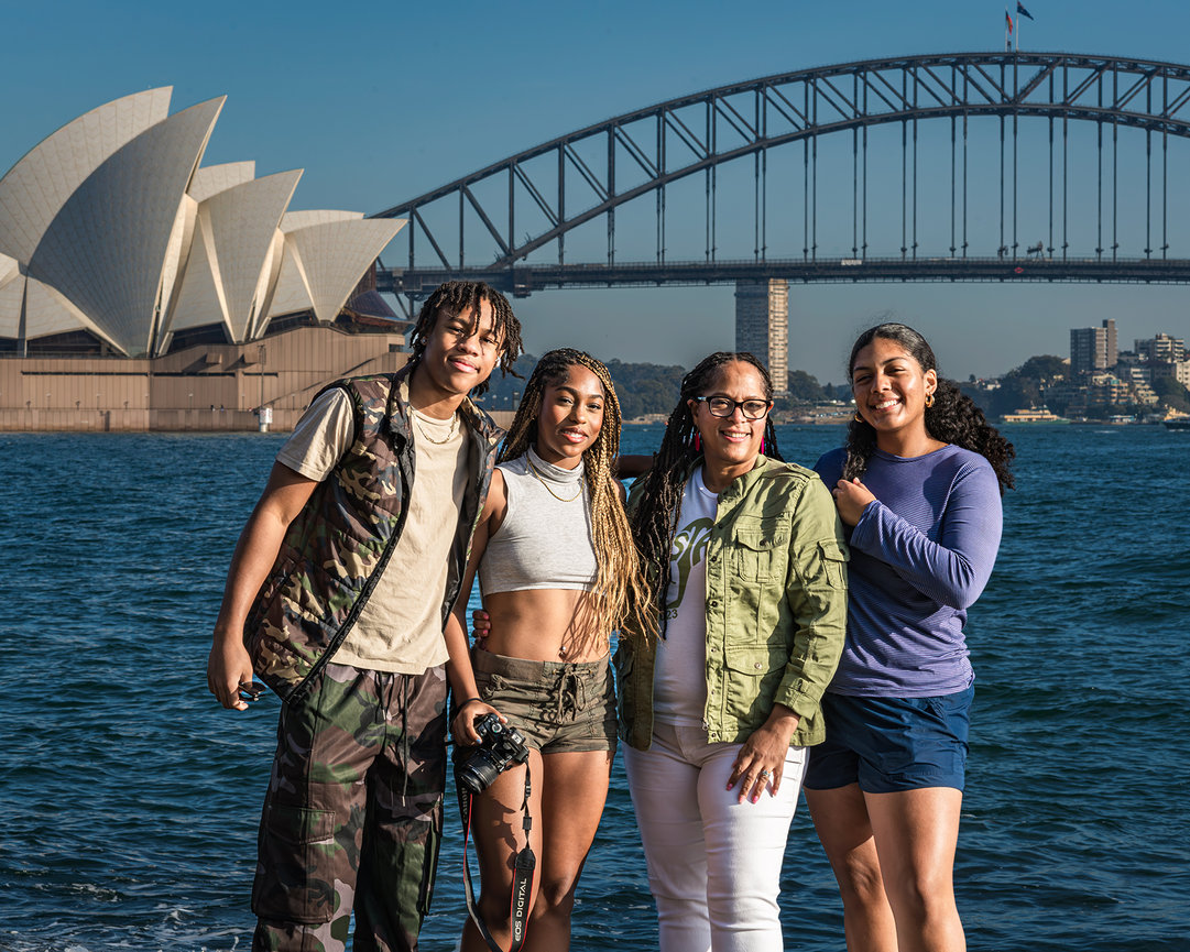 Destination senior portrait of group of four friends in front of Sydney Opera House and Harbour Bridge in Australia, international travel session by Master Photographer Ty Swartz, Swartz Portraits luxury destination senior photography