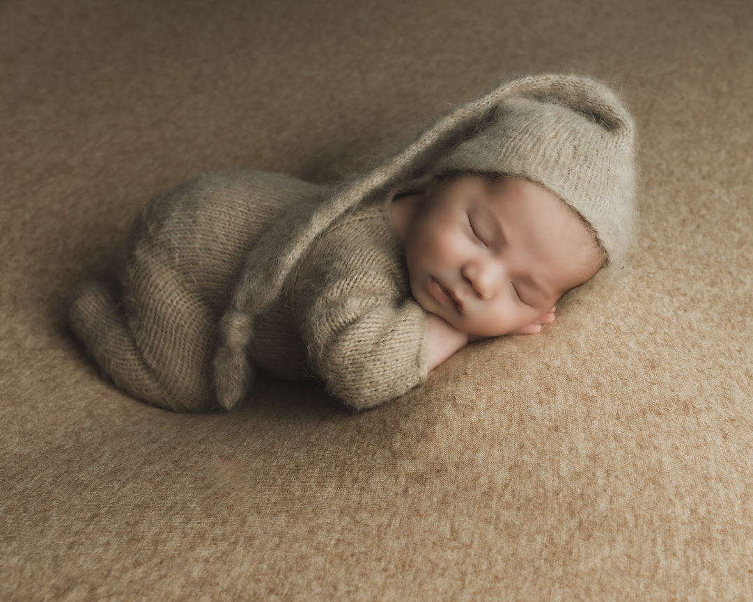 Baby sleeping in a cozy suit with bunny ears