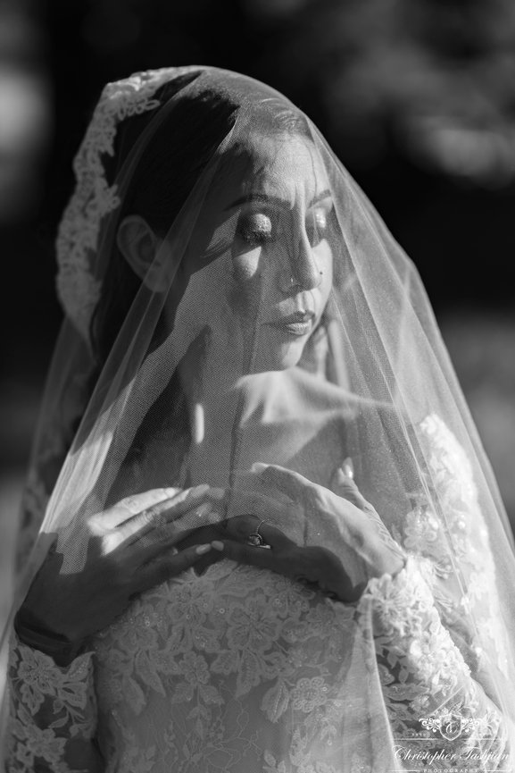 Bride under lace veil in black and white