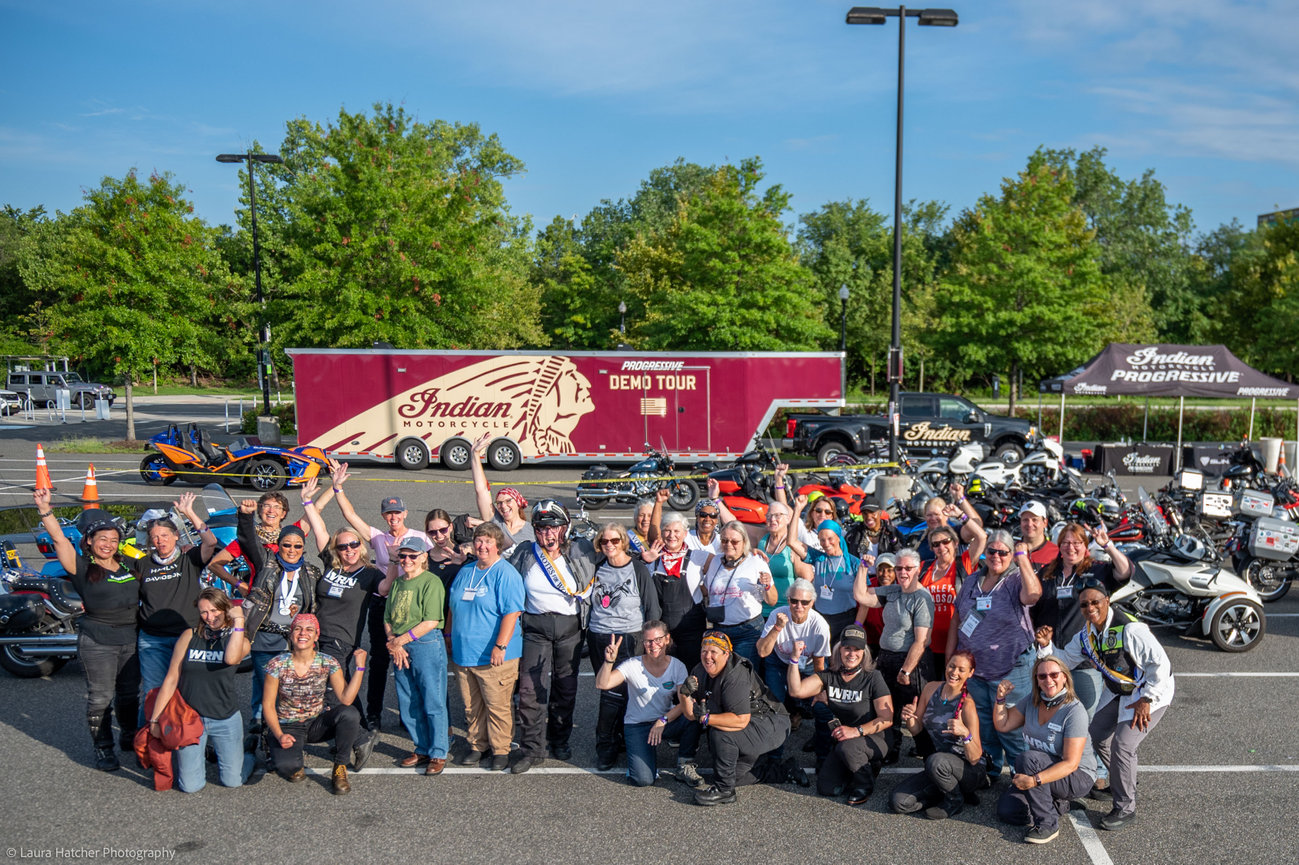 Women motorcycle riders posing together