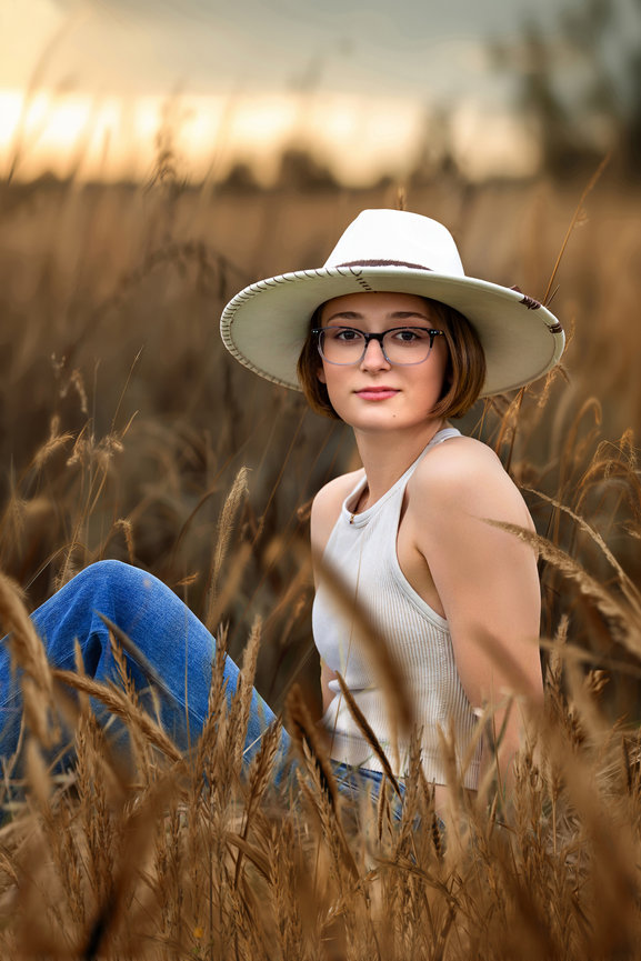 High school senior wearing a white hat during an outdoor senior portrait session in Wooster, Ohio.
