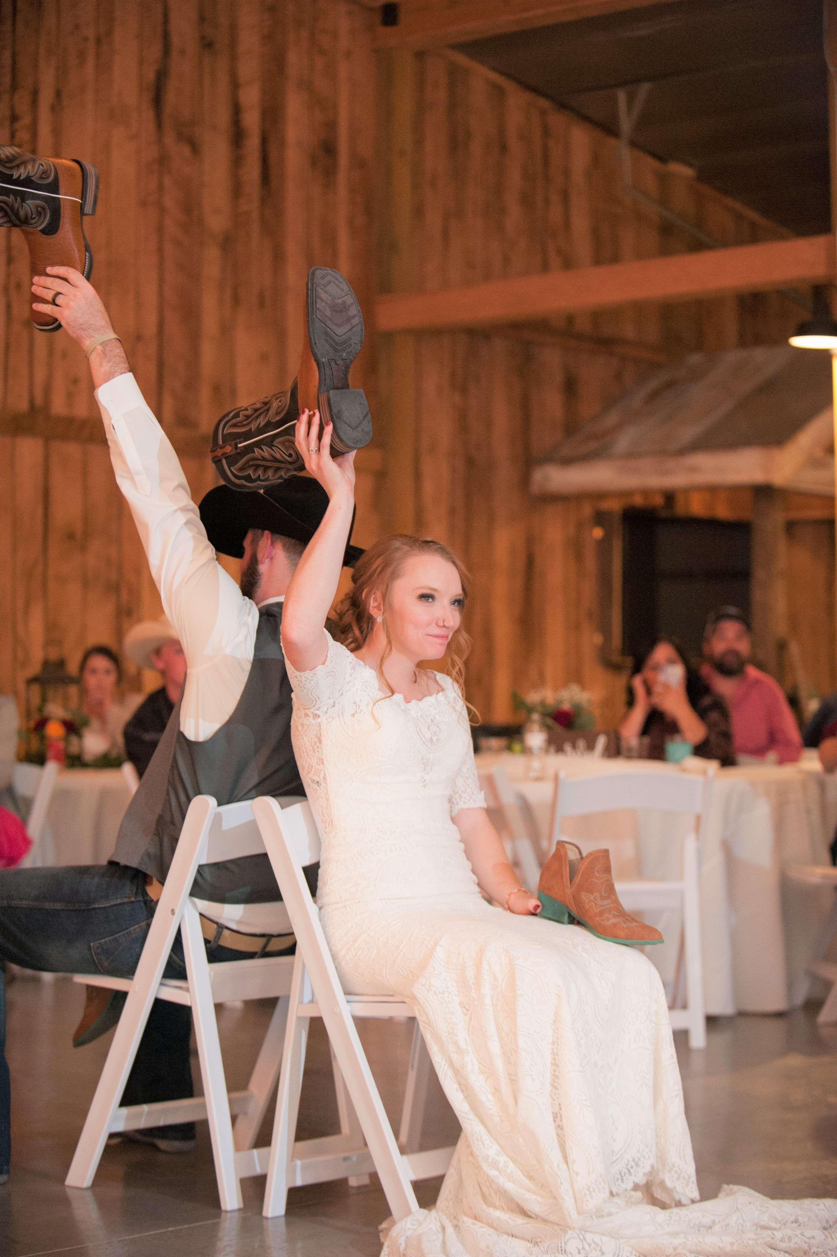 Bride and groom playing the shoe game at wedding reception near Springfield, Missouri.