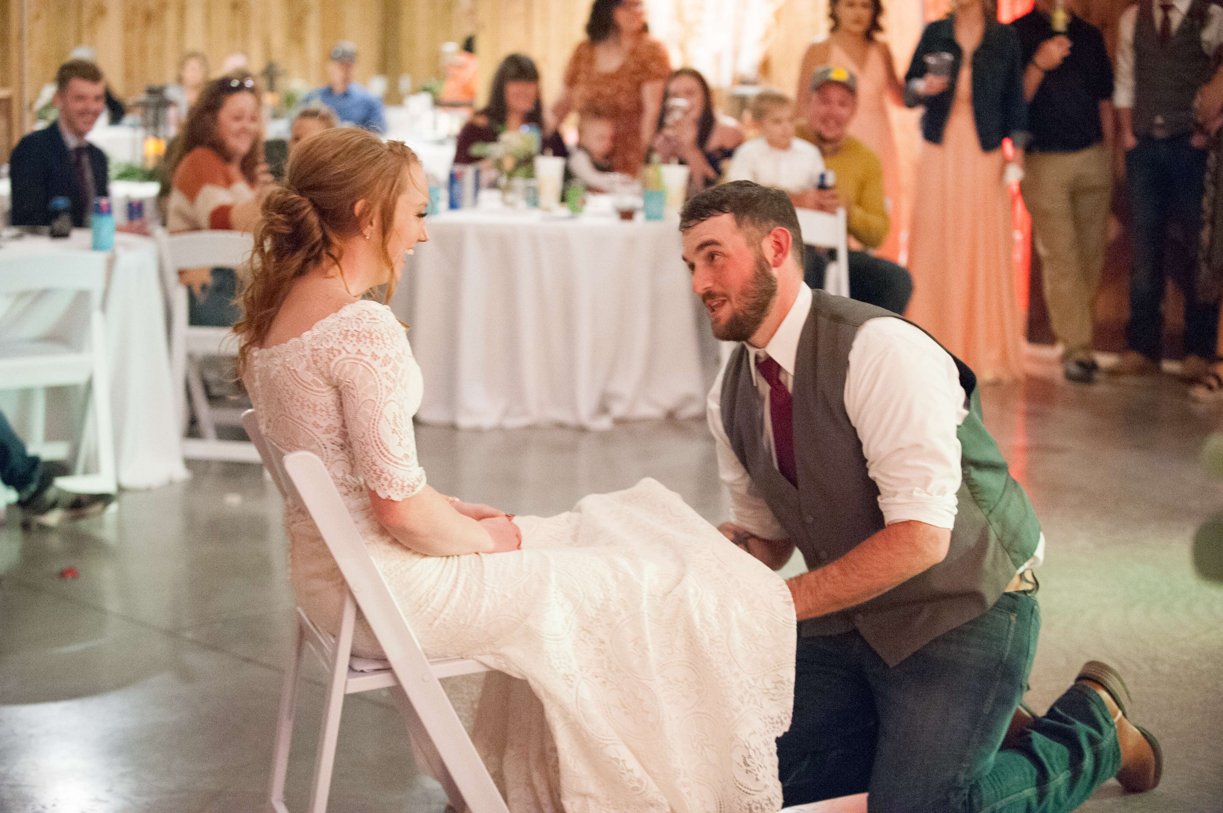 Groom removing bride's garter at wedding reception near Springfield, Missouri.