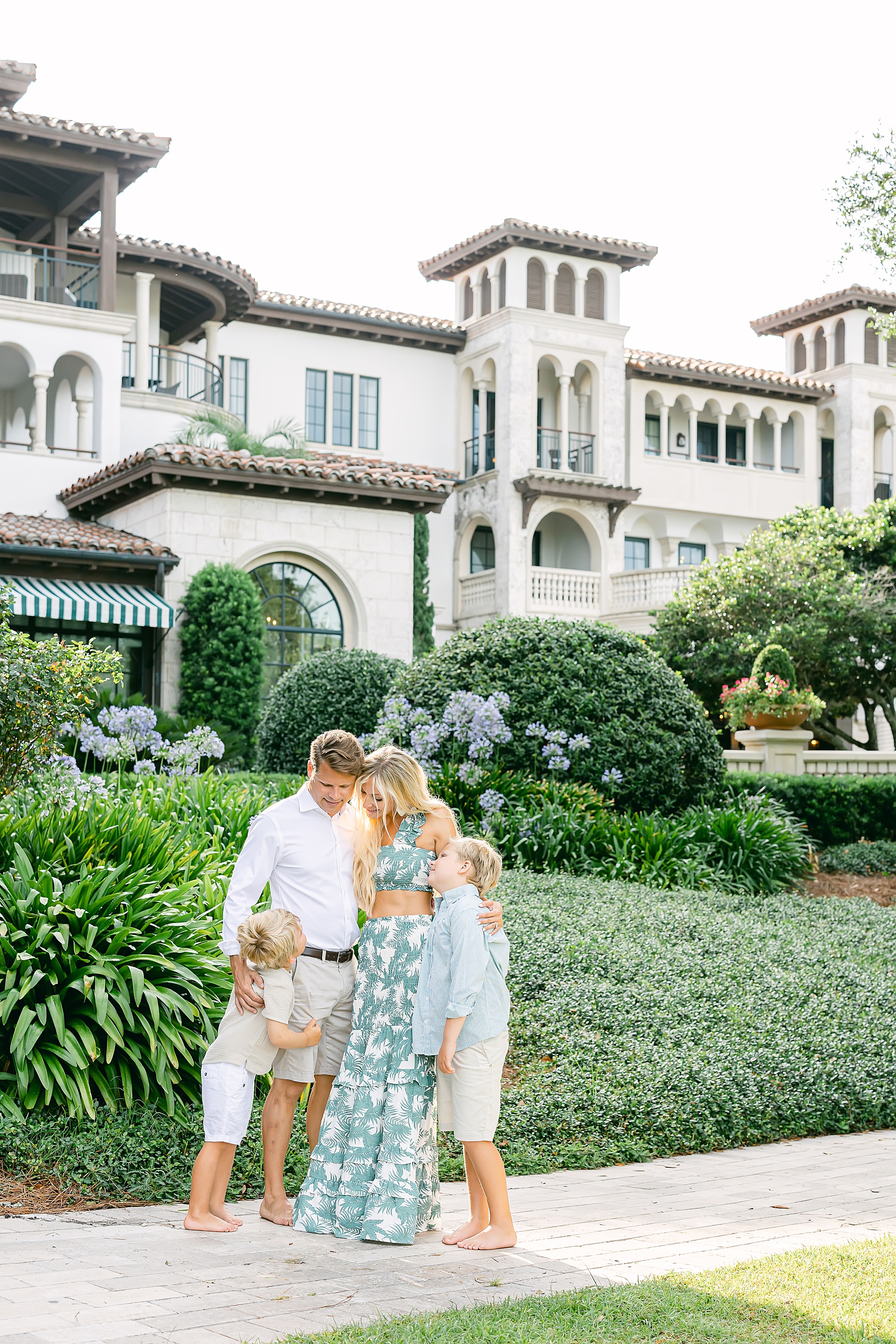 family wearing green and white standing in front of the cloister at sea island georgia