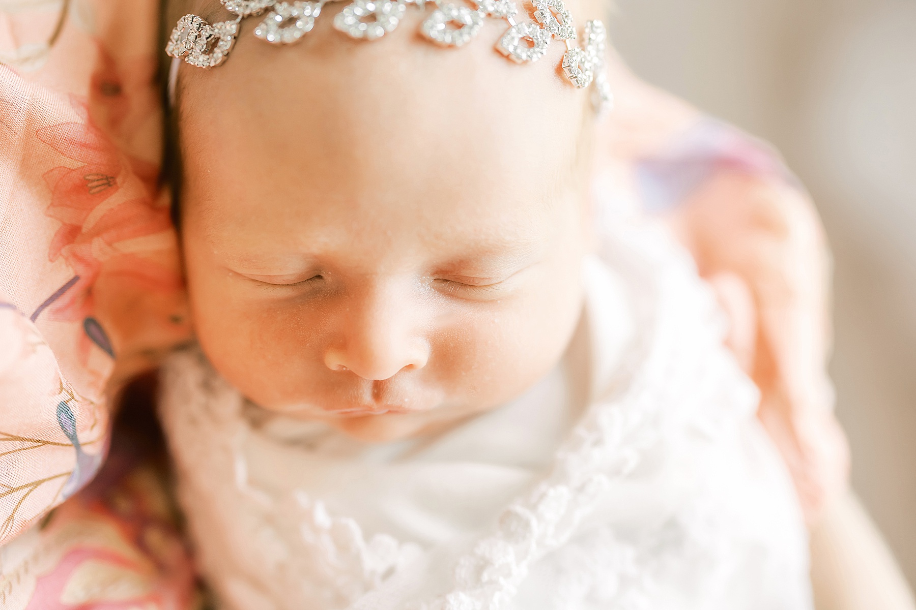 newborn baby girl dressed in pink wearing a rhinestone tieback glitter shimmer