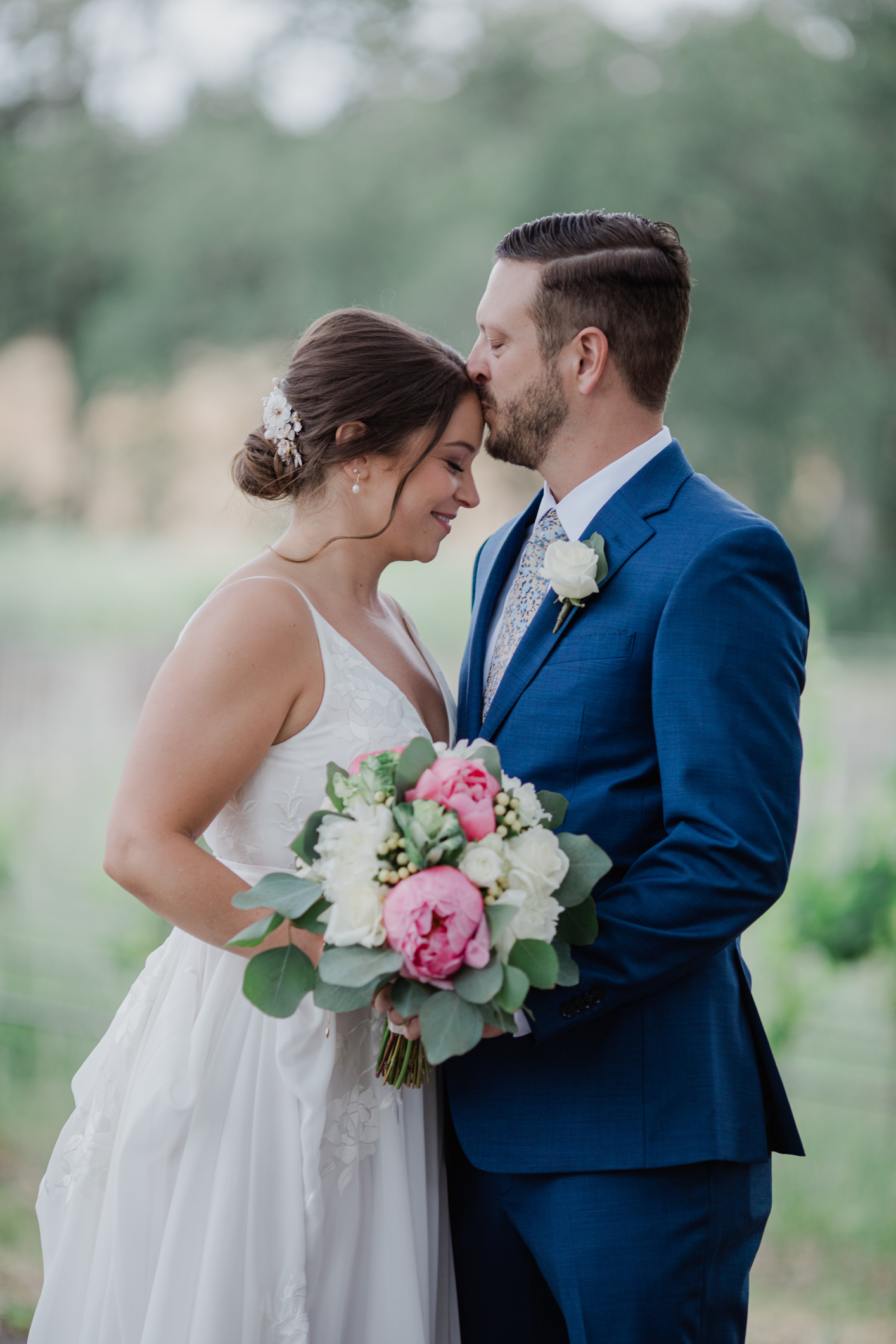 Groom Kissing the top of Brides head at Russian River Vineyards