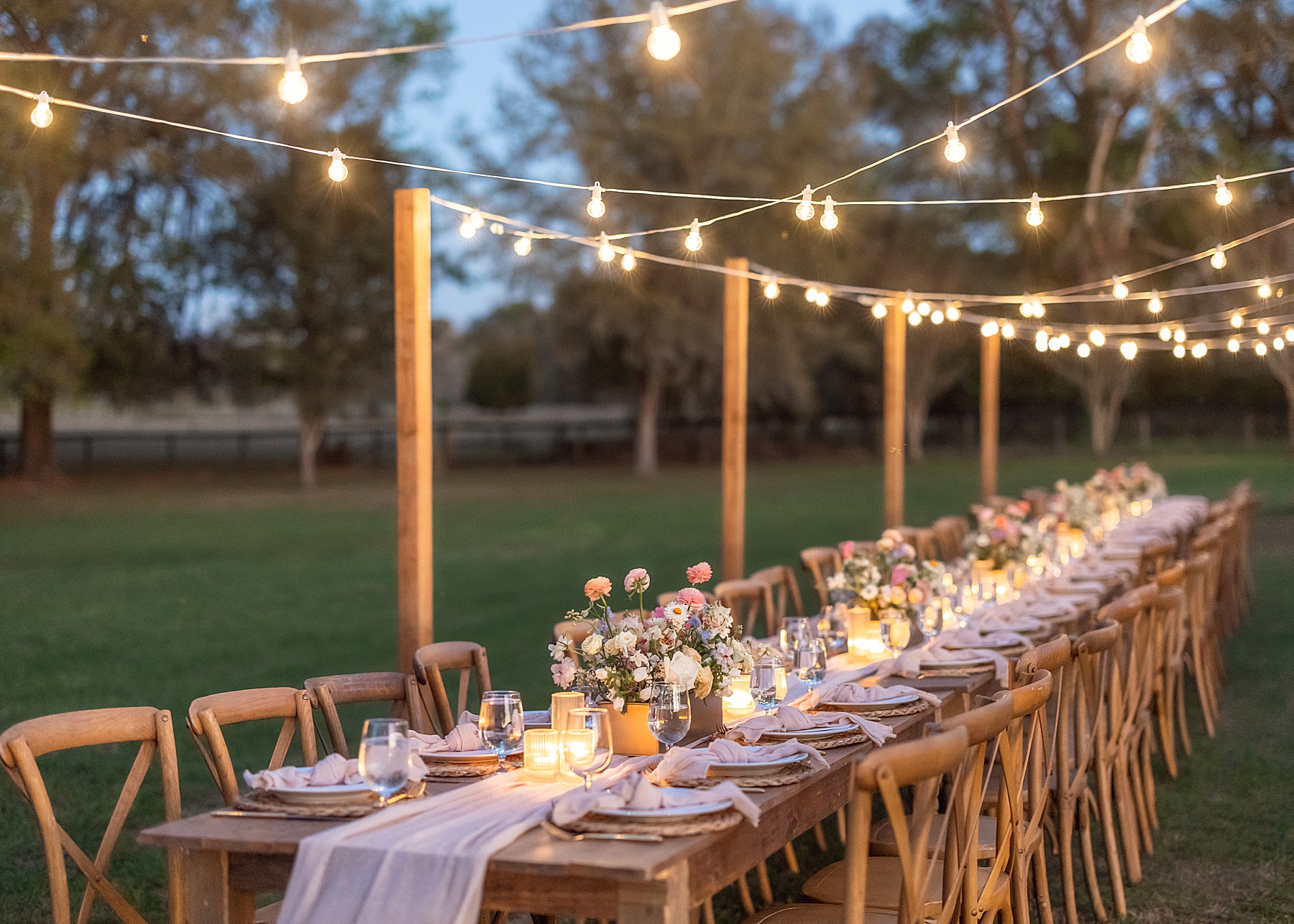 backyard wedding in Jacksonville florida, French farmhouse rustic wedding table setting with lights early evening, peach and pink florals