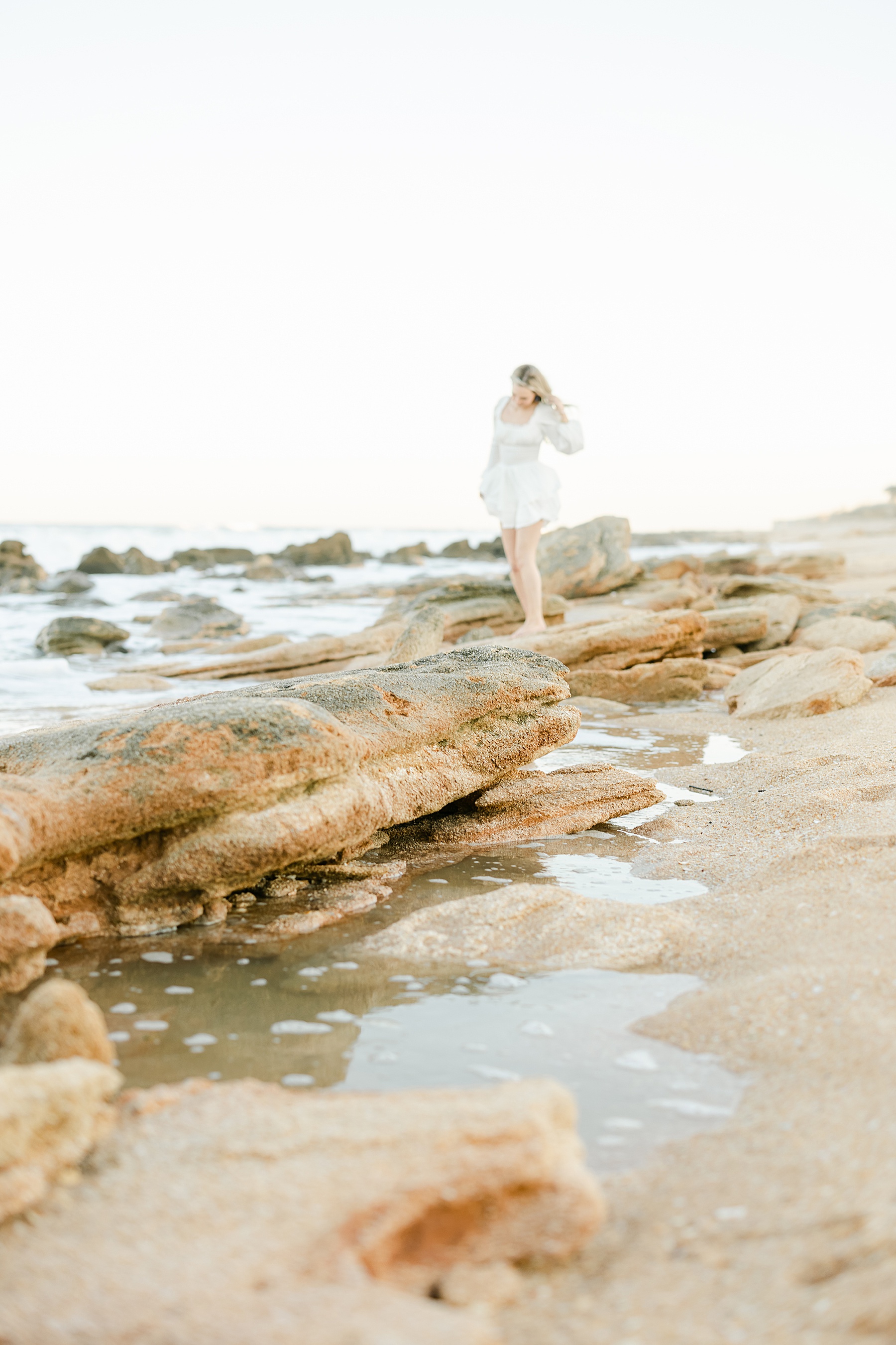 blonde woman wearing white romper on the beach in marineland florida