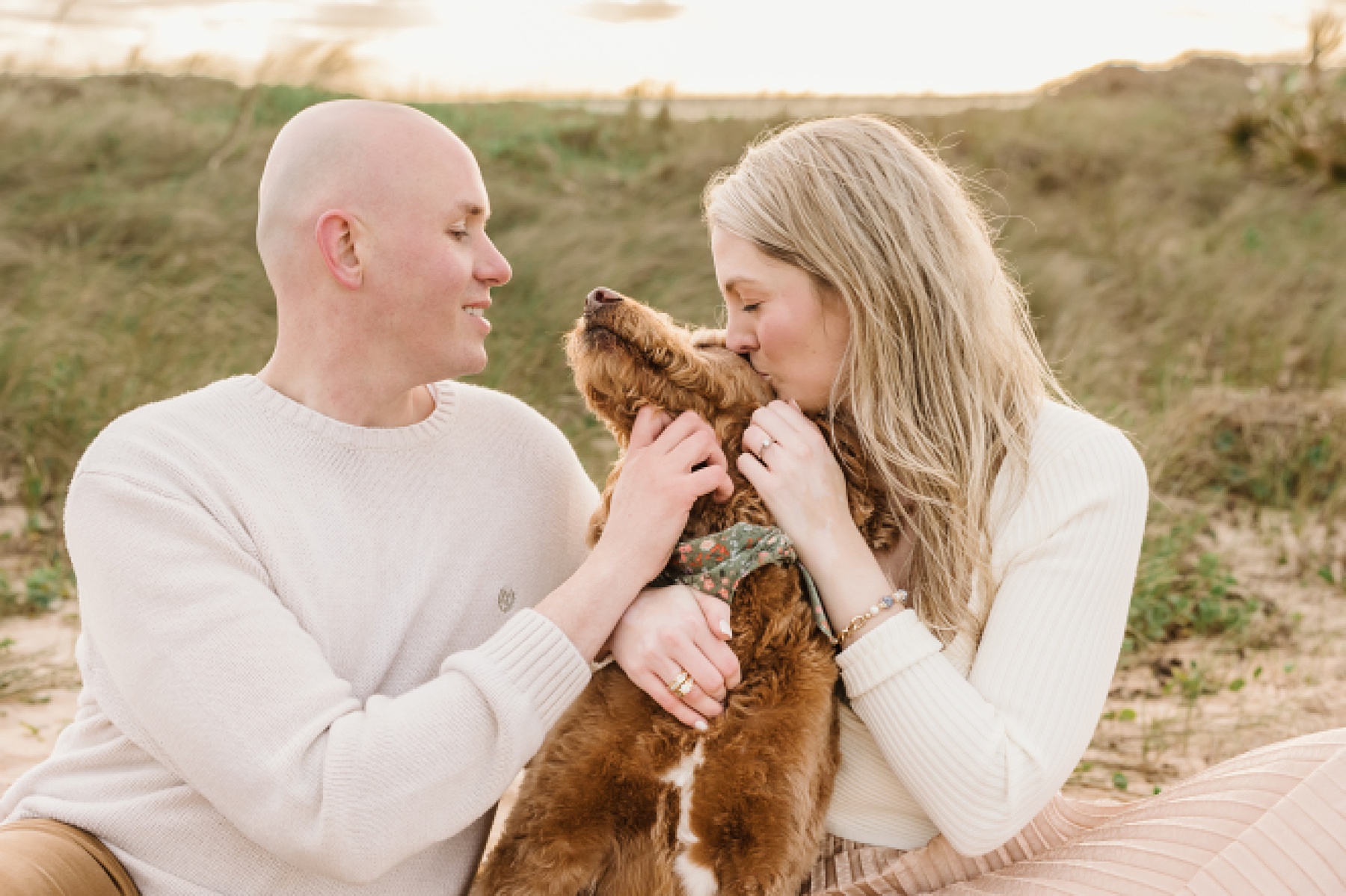 engagement portrait on the beach of couple with dog