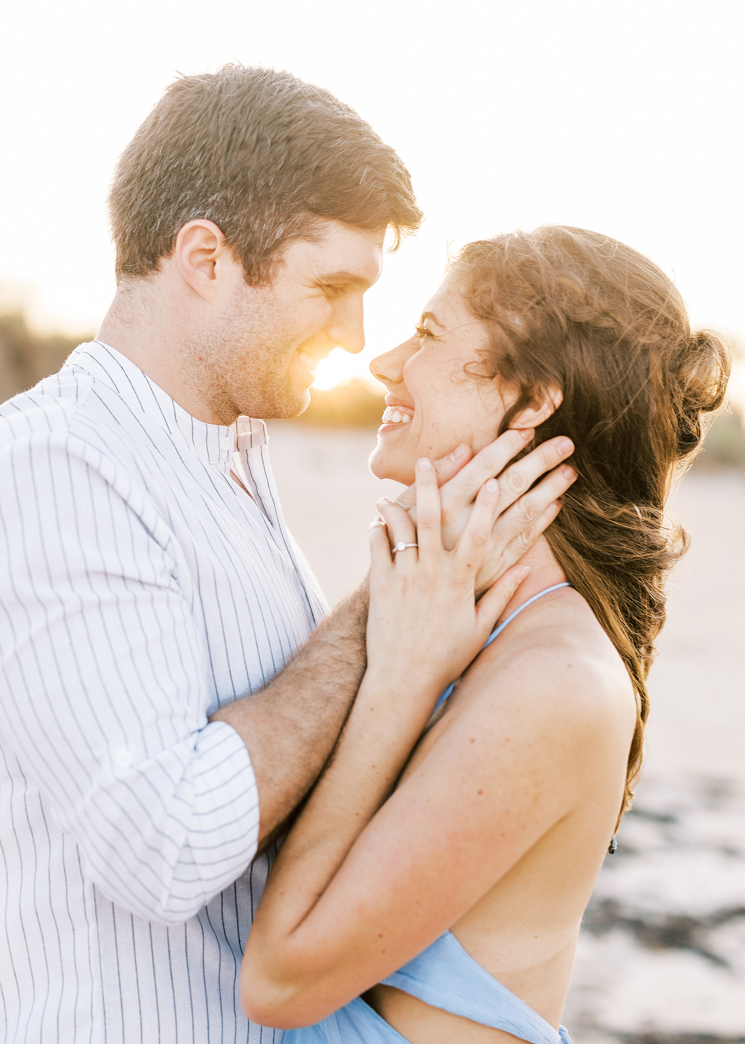 man and woman holding each other close at sunset on the beach in St. Augustine