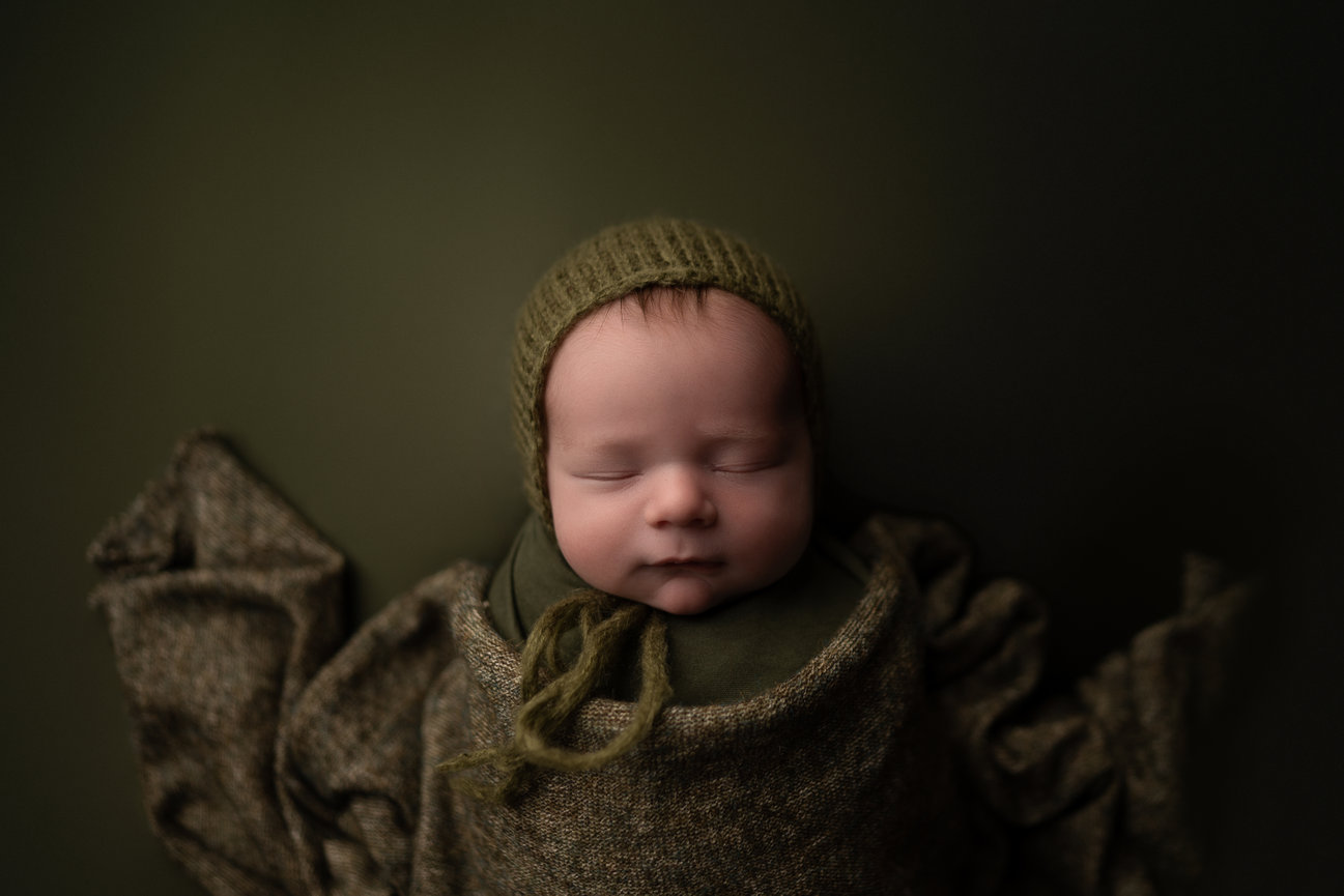 Newborn baby wrapped with a bonnet la Crosse Wi