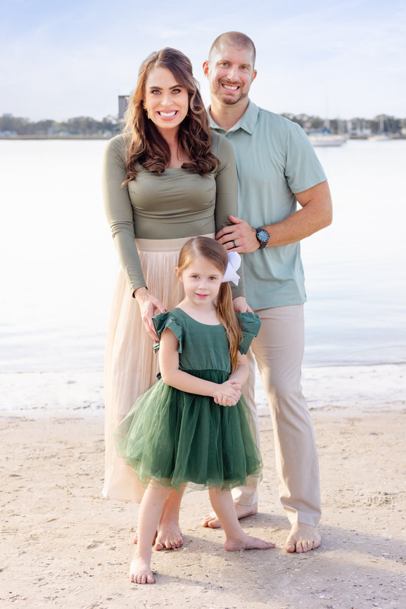 Mom Dad and daughter on Davis Island beach