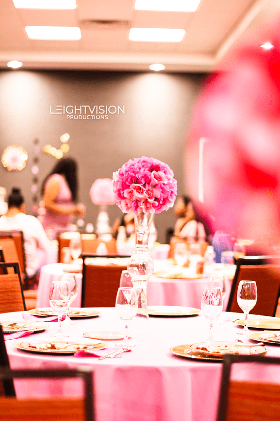 A table featuring a pink tablecloth, adding a cheerful and warm ambiance to the setting.