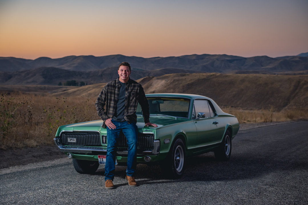 Senior year photo of guy with a classic car at sunset in Eagle, Idaho
