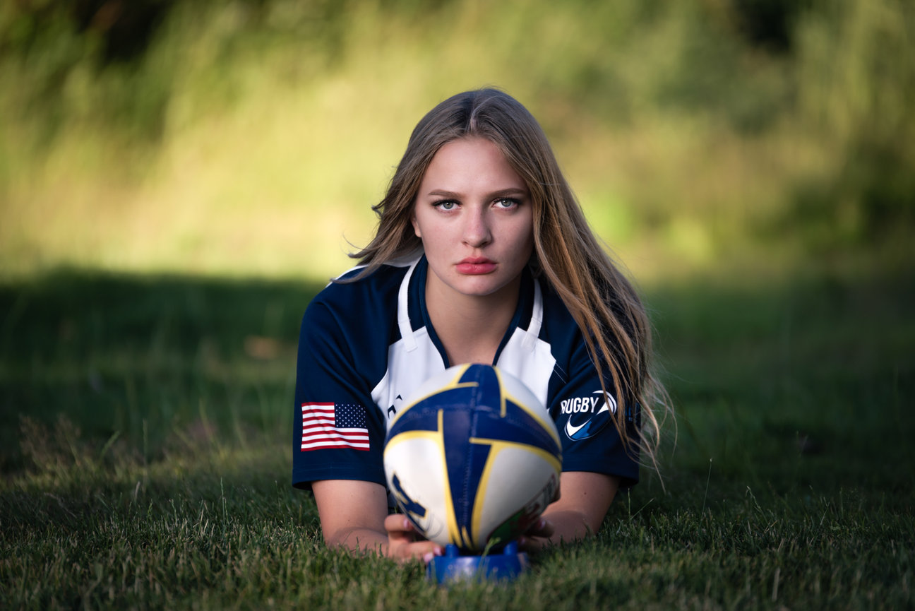 Girl senior year photo of girl in a park with rugby ball and uniform. Meridian, IDAHO