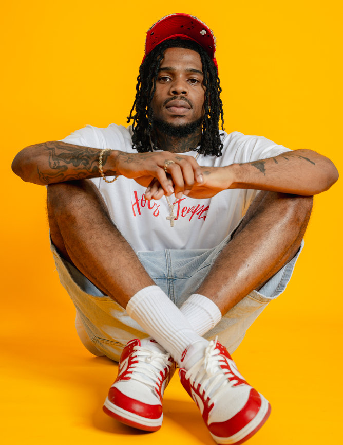 Man sitting cross-legged wearing casual clothes