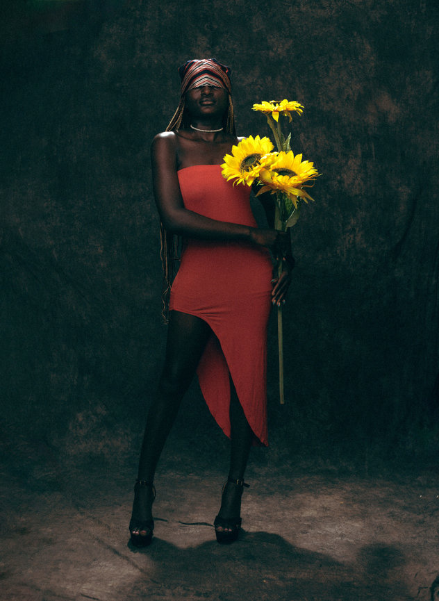 Woman holding sunflowers in studio