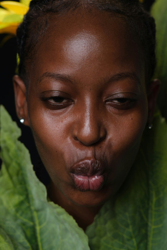Woman with leaves around face