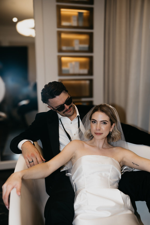 An unconventional, relaxed wedding moment in a King Street Townhouse suite, captured with our signature editorial flash style.