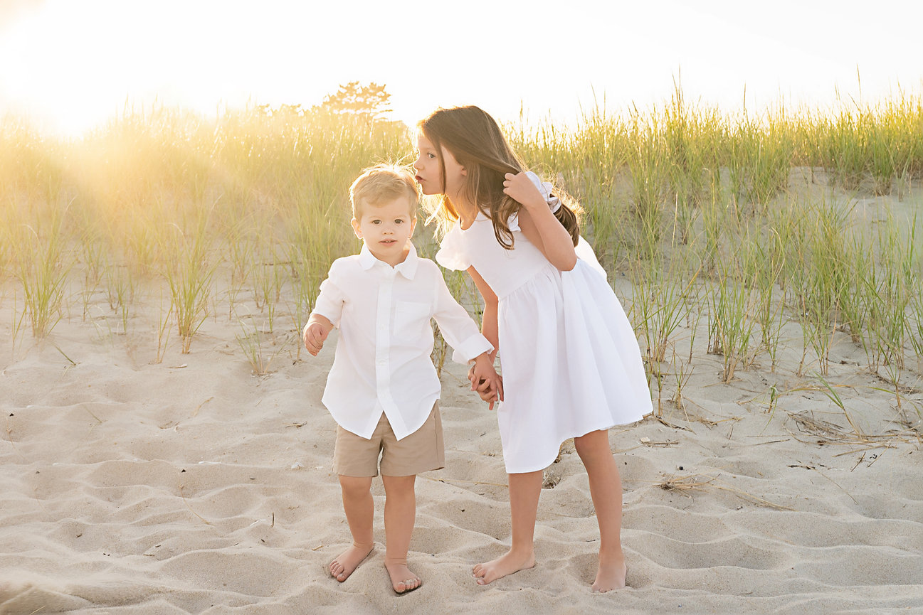 Candid moment of sibling love during beach session