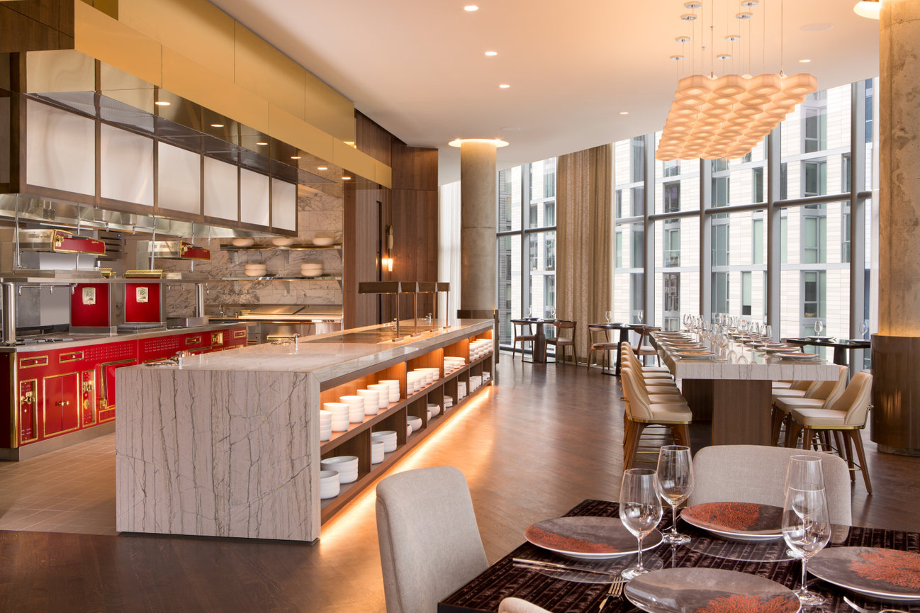 Conrad DC Restaurant with beautifully designed open kitchen and marble tables throughout.