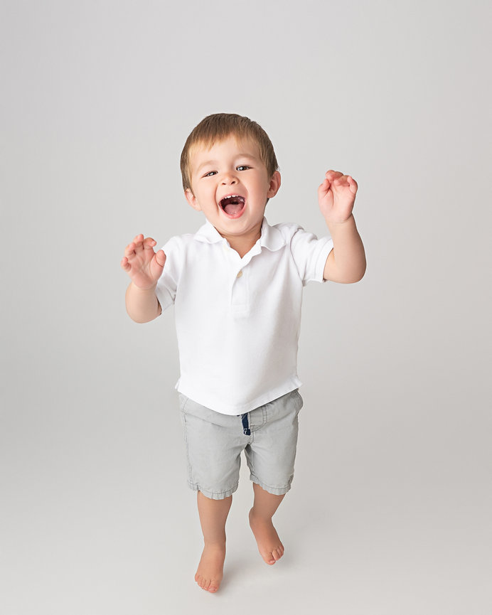 Toddler looking up with wonder in light-filled NJ photo studio