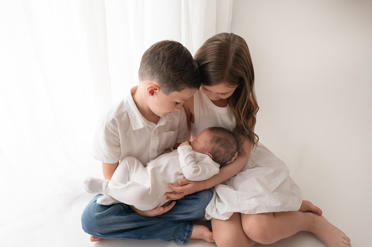 Sibling meets newborn for the first time in a relaxed Wall Township studio session
