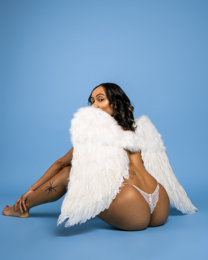 Back view of woman with angel wings on blue background