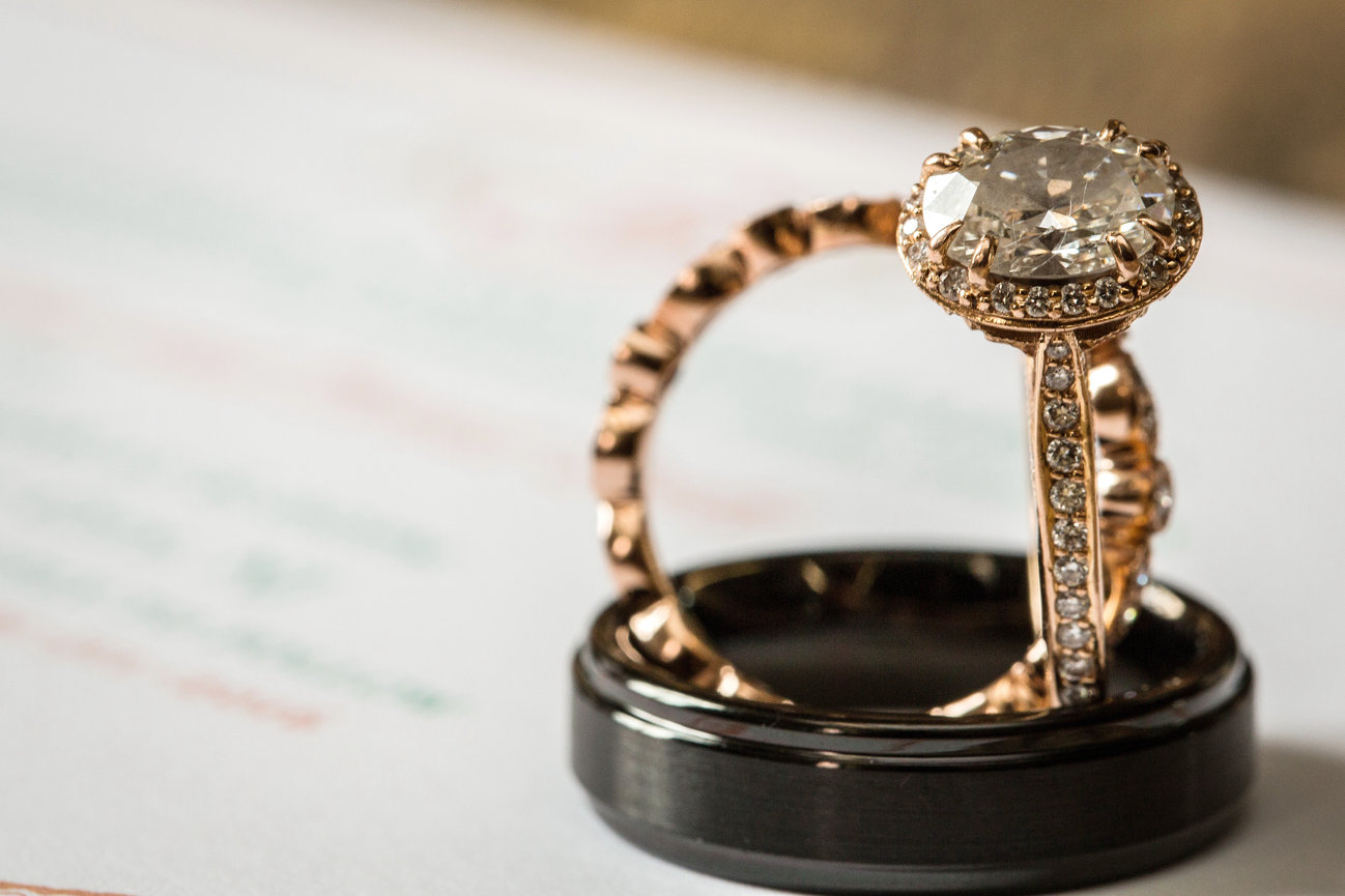 Engagement ring and wedding band in a ring box detail shot