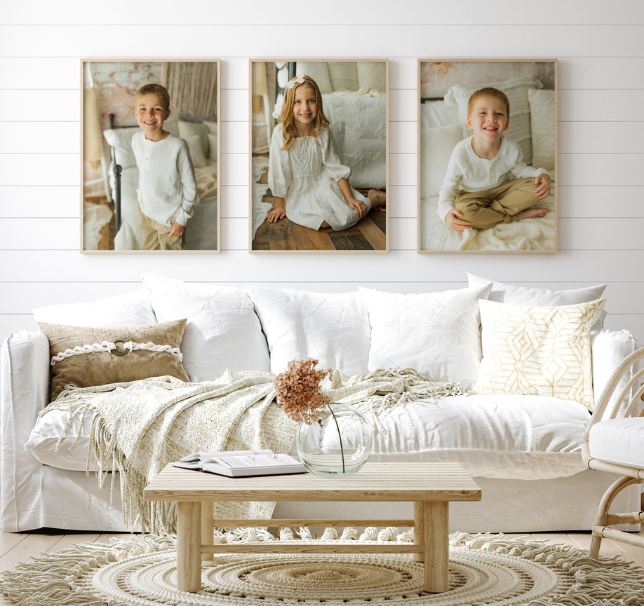 Children portraits framed and hung behind couch setting