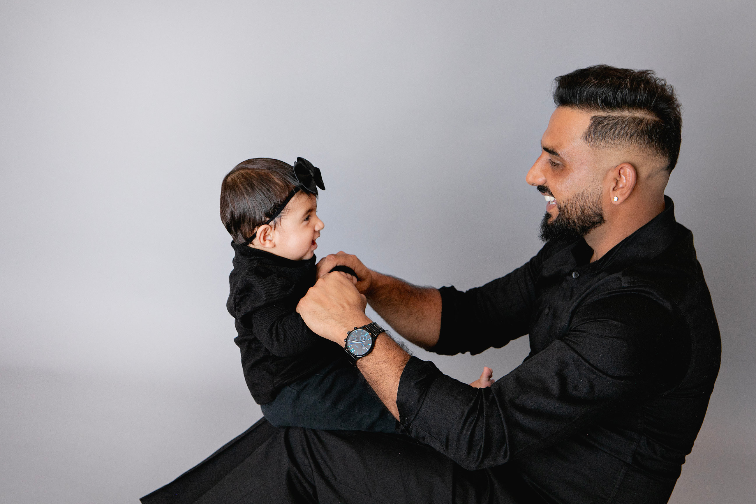 Father lifting his baby during a playful studio portrait