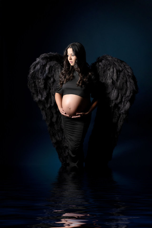 Maternity model wearing black wings