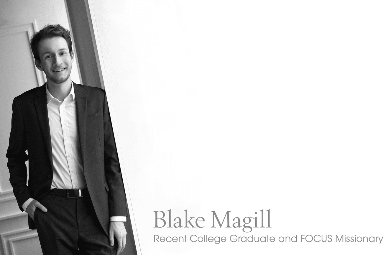 A male college graduate  in a suit jacket posing for a missionary job application.