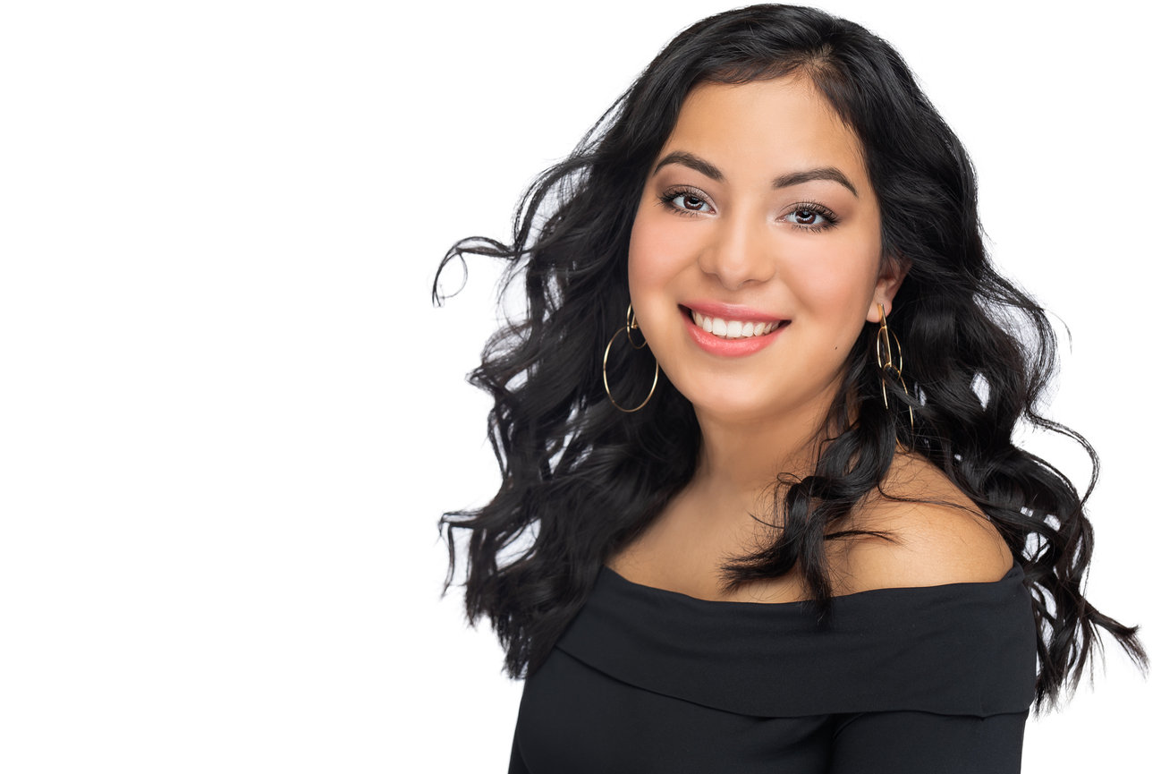 white background in studio headshot of a young lady for her senior portrait