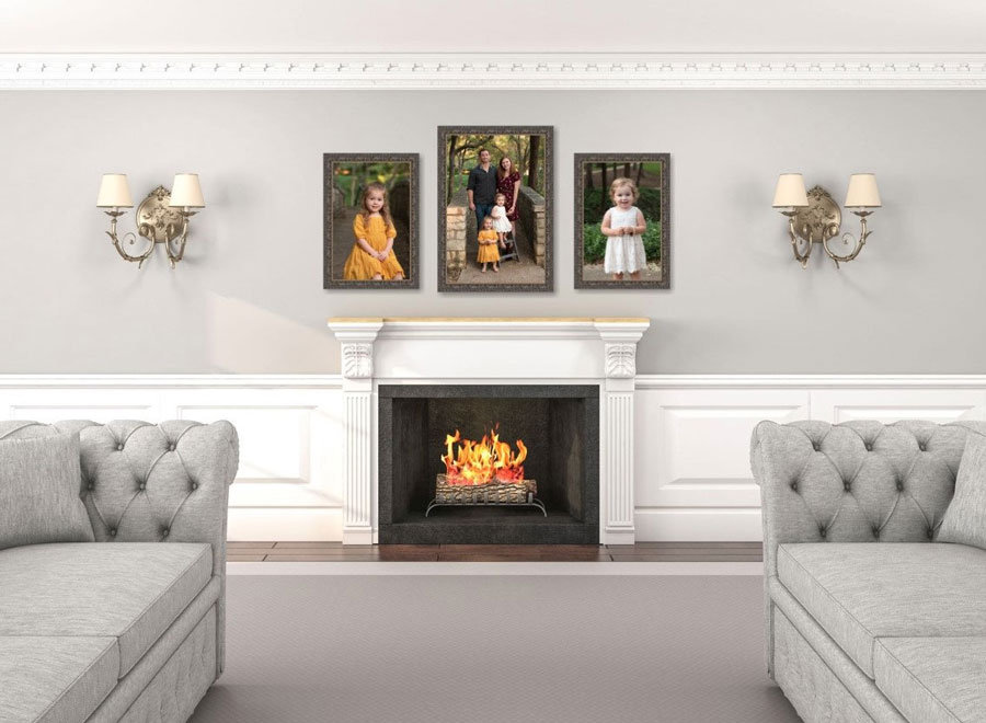 Living room with a fireplace, framed family portraits above, sconces on each side, and two gray tufted sofas.