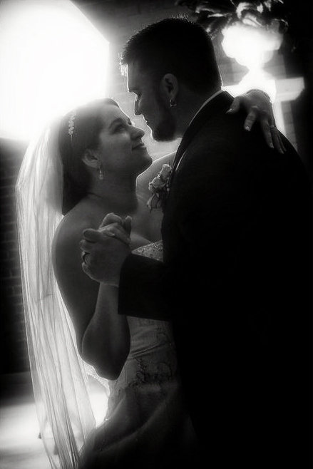 From Kristin & Cory's reception,  sharing their first dance, backlit for a soft, romantic effect with PBM Photography