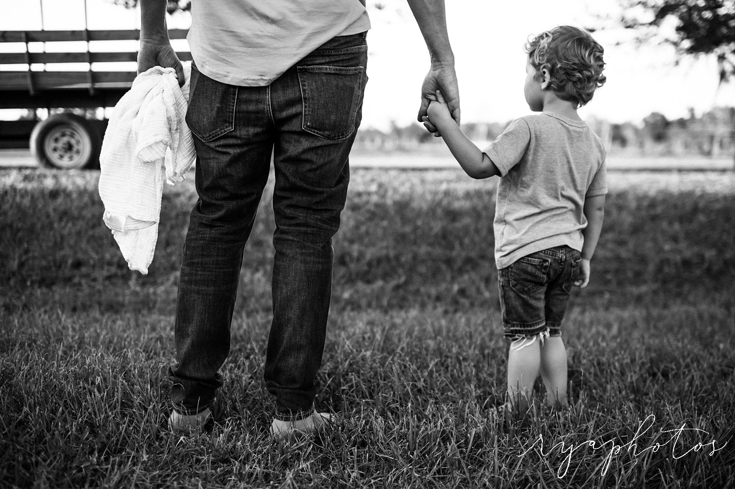 father son portrait, black and white image, dad holding child's hand, Ryaphotos, Jacksonville, Florida