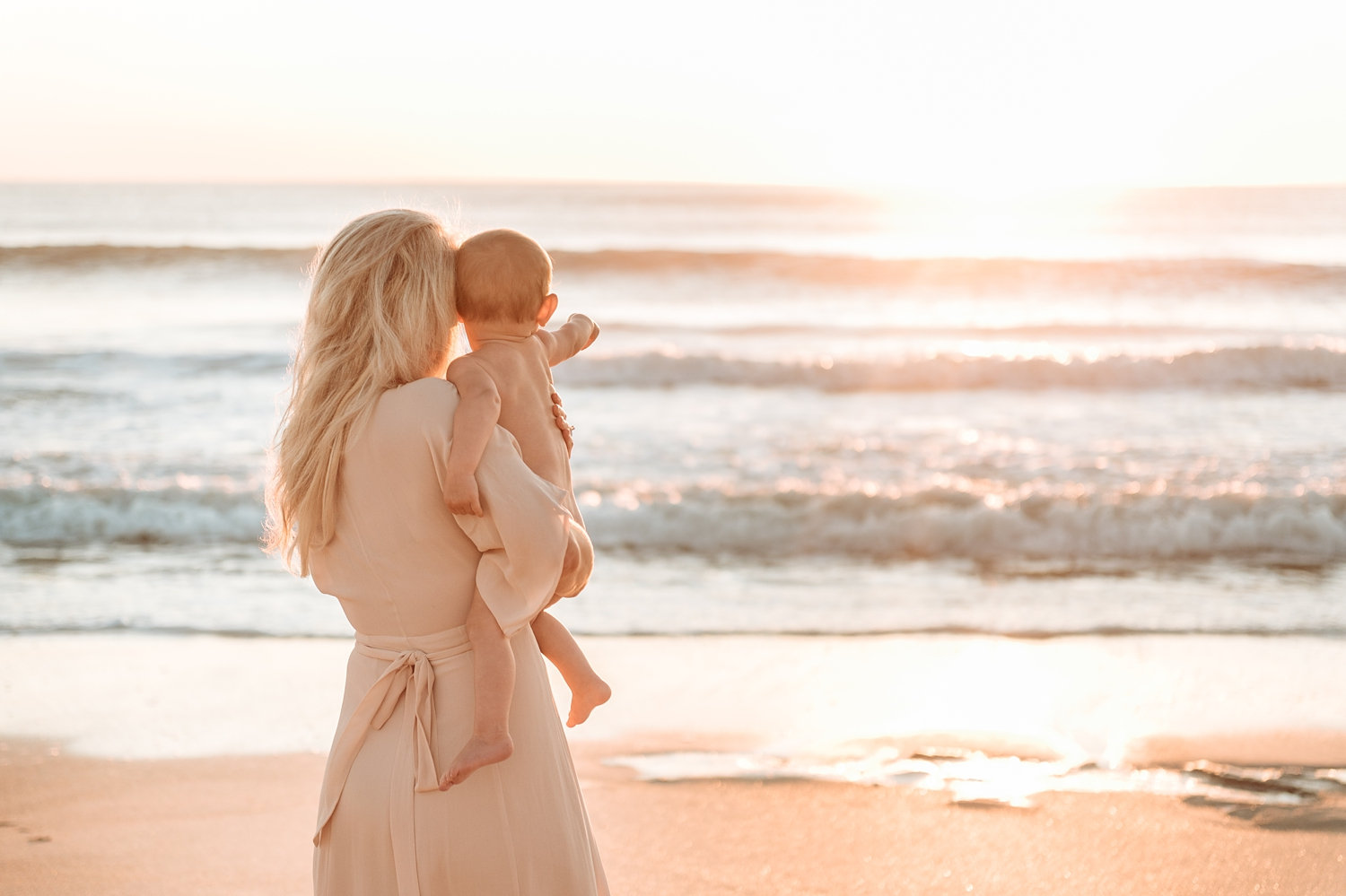 blonde mother and baby staring into the ocean, coastal motherhood session, Ryaphotos